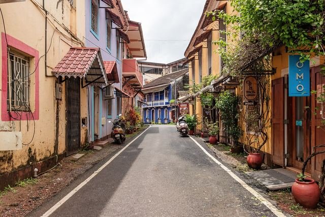 A quiet street in Fontainhas lined with yellow, orange and blue colonial-era houses