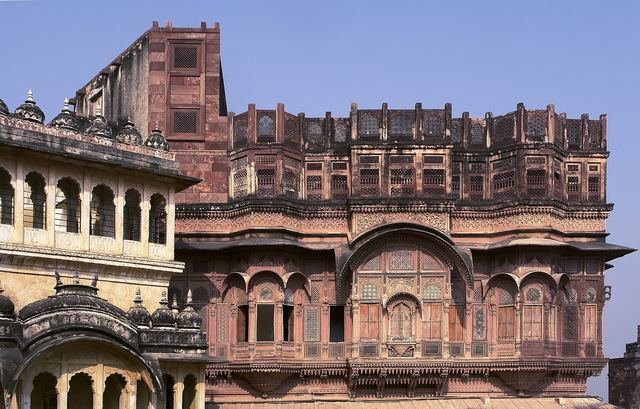 Intricately carved red sandstone balconies and latticed windows of the palaces inside Mehrangarh Fort